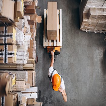 Young man working at a warehouse with boxes